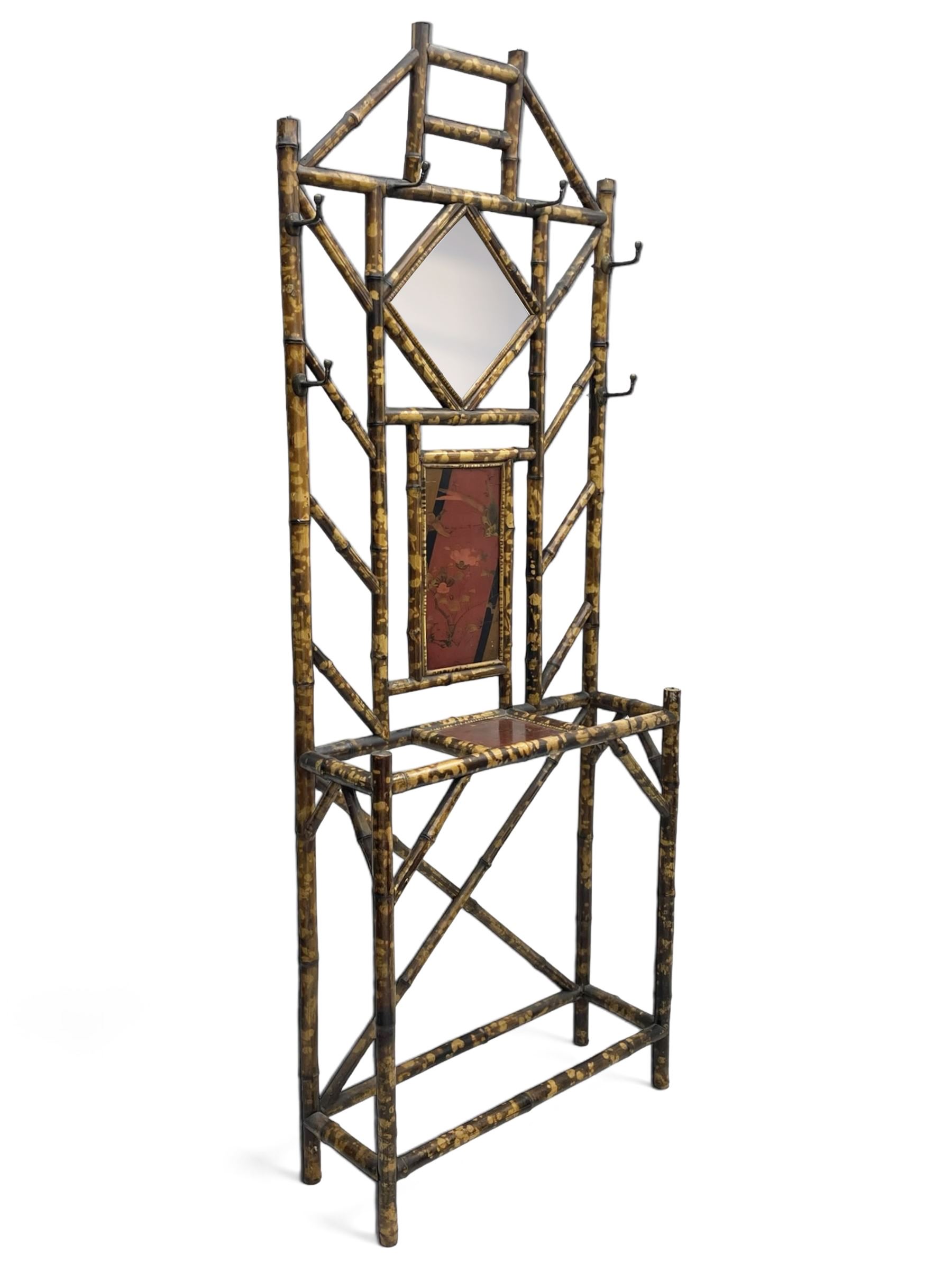 Victorian bamboo hallstand, bevelled mirror over red lacquered and chinoiserie decorated panels, fitted with six brass hooks 