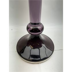 Large heavy gauge Scandinavian amethyst glass candlestick, the plain column with flared rim and basel knop, upon a spreading circular base, H44cm