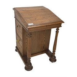 19th century pitch pine Davenport desk, sloping hinged top, fitted with four drawers, on turned column supports, turned compressed feet with castors 