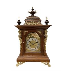 Junghans-German early 20th century walnut cased 8-day mantle clock, with an ogee carved pe...