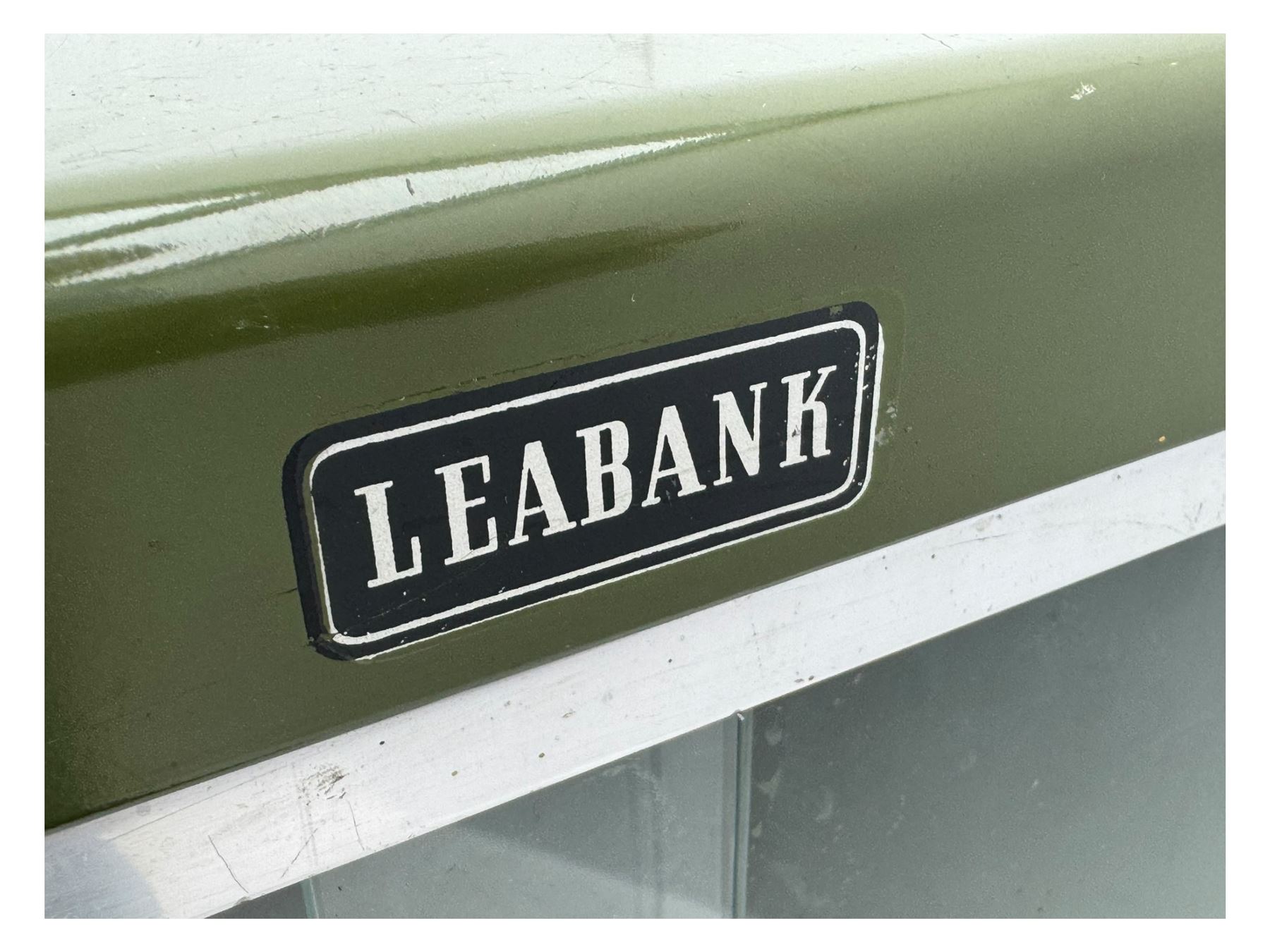 Mid-20th century 'Leabank' metal display cabinet, two sliding glass doors enclosing two adjustable metal shelves, olive green finish with chrome trim