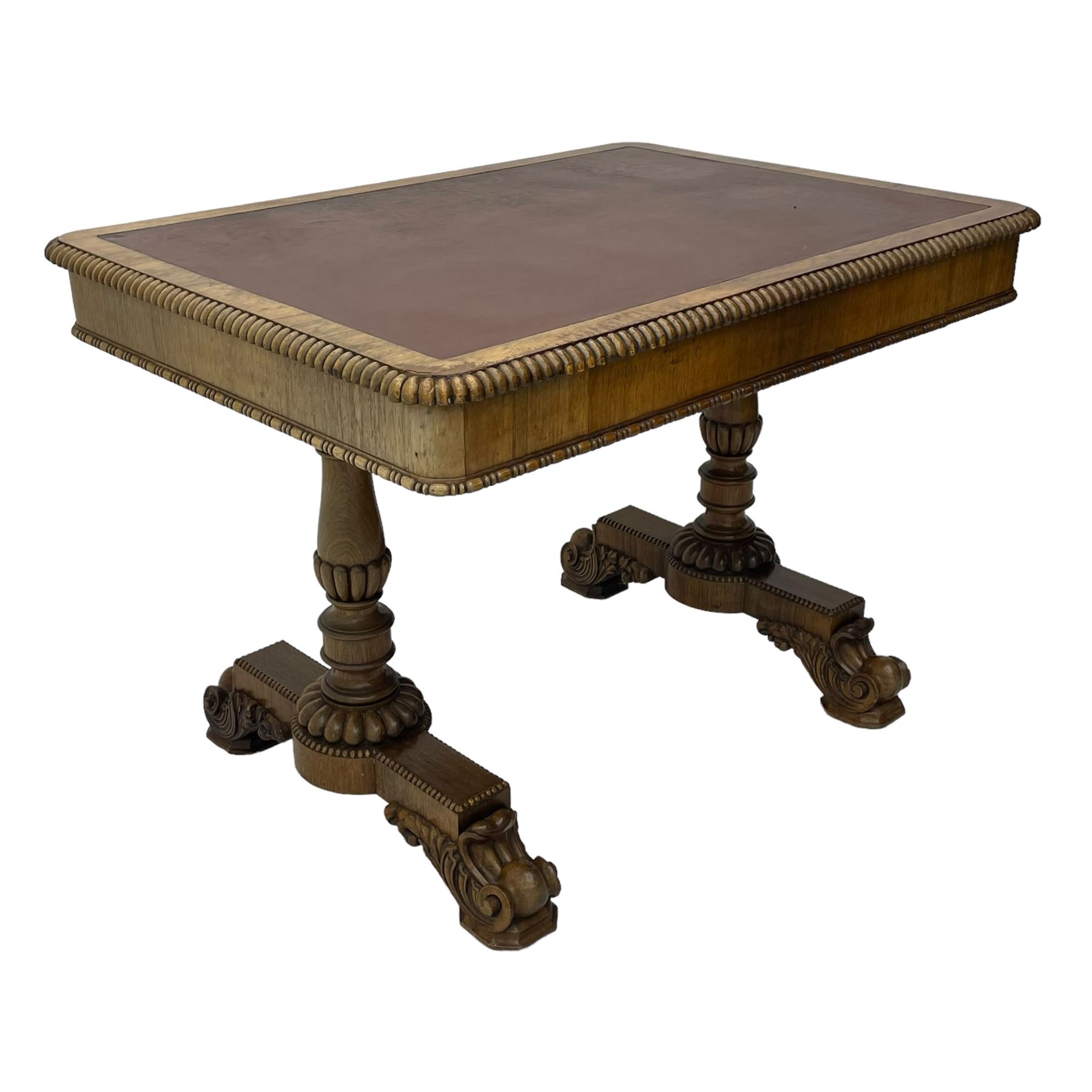 Early 19th century Regency rosewood writing table, rectangular top with inset leather writing surface and gadroon moulded edge, fitted with single frieze drawer, on twin turned pillar supports with lobe carved balusters, on platforms with beaded edge, acanthus scroll carved feet