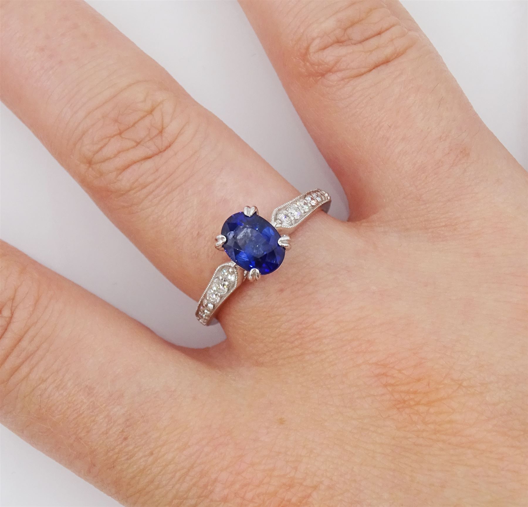 18ct white gold oval cut sapphire ring, with milgrain set round brilliant cut diamond shoulders, hallmarked, sapphire approx 0.80 carat, total diamond weight approx 0.40 carat