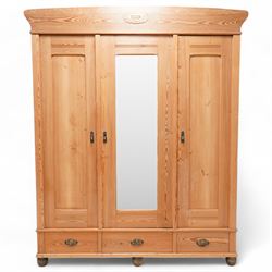 19th century pine triple wardrobe, enclosed central bevelled mirror glazed door and flanki...