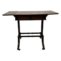 Mahogany drop-leaf sofa table, rectangular top over single frieze drawer with carved rosette handle, twin turned columns united by twin stretchers, on splayed supports terminating in paw feet with castors