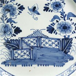 18th century English Delft charger, decorated in underglaze blue with a fence and peony, within a floral and geometric border, D35cm