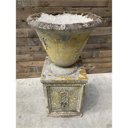 Cast stone vase shaped urn, mounted on square plinth