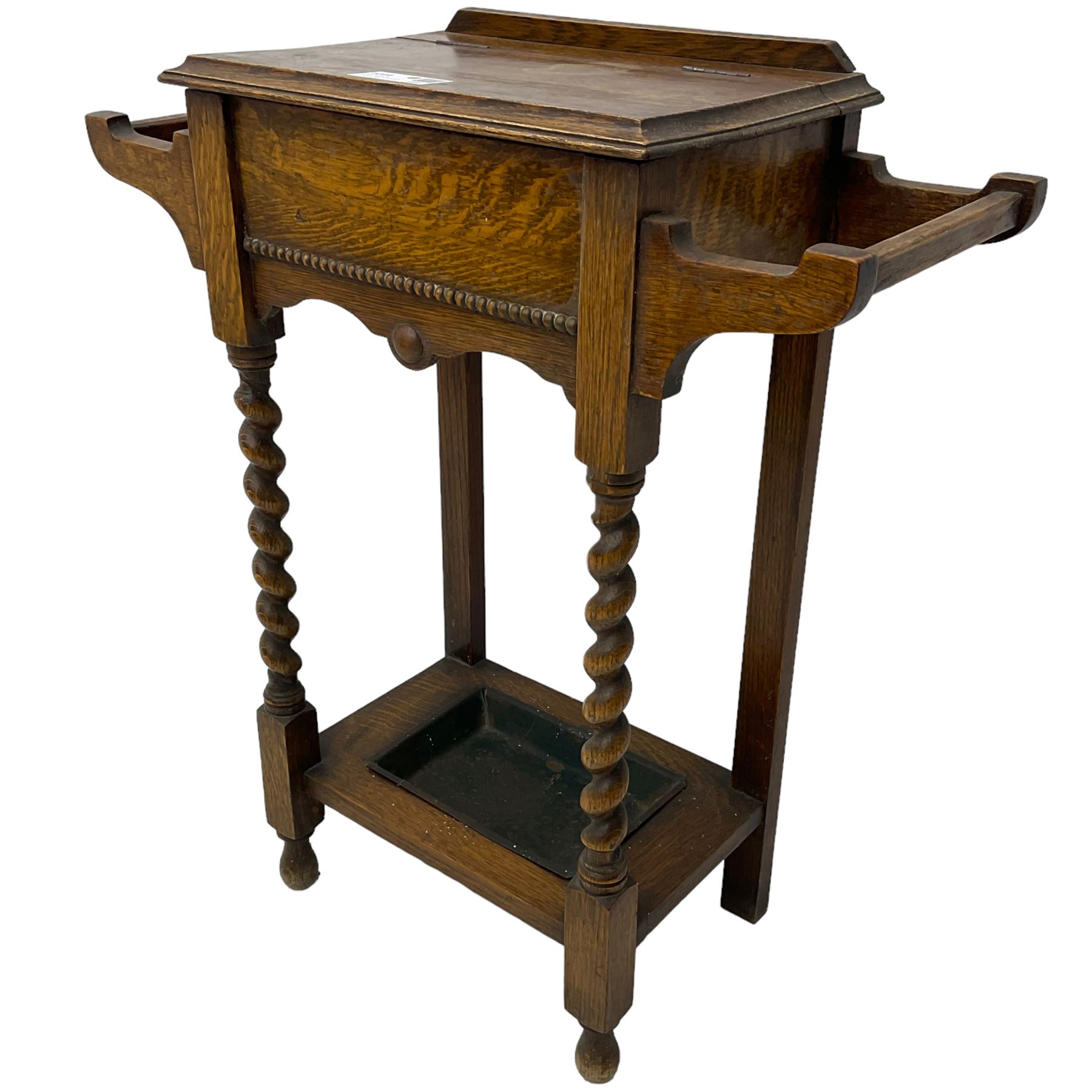 Early 20th century oak work table or hall stand, rectangular top with hinged lid enclosing interior storage, side hanging handles, barley twist supports united by square stretchers, on turned feet