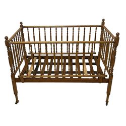 Victorian beech and pitch pine crib, turned spindle gallery supports, raised on square tapering supports with castors