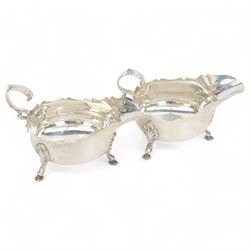 Pair of Edwardian silver sauce boats, of typical plain form with shaped rim and flying C s...