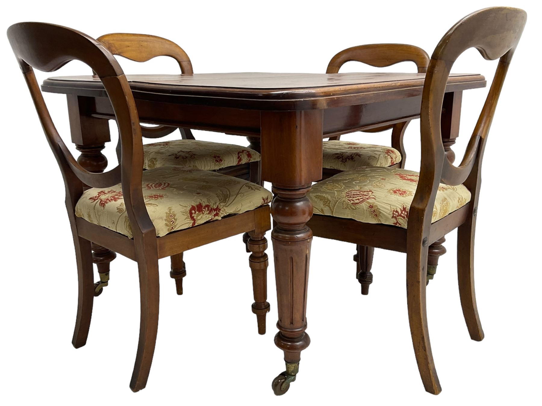 Victorian mahogany dining table, telescopic extending action, moulded rectangular top with rounded corners, single additional leaf, on turned and fluted supports with brass and ceramic castors; and a set of four Victorian mahogany dining chairs, balloon back over upholstered drop-on seat in floral pattern fabric, on turned front supports 