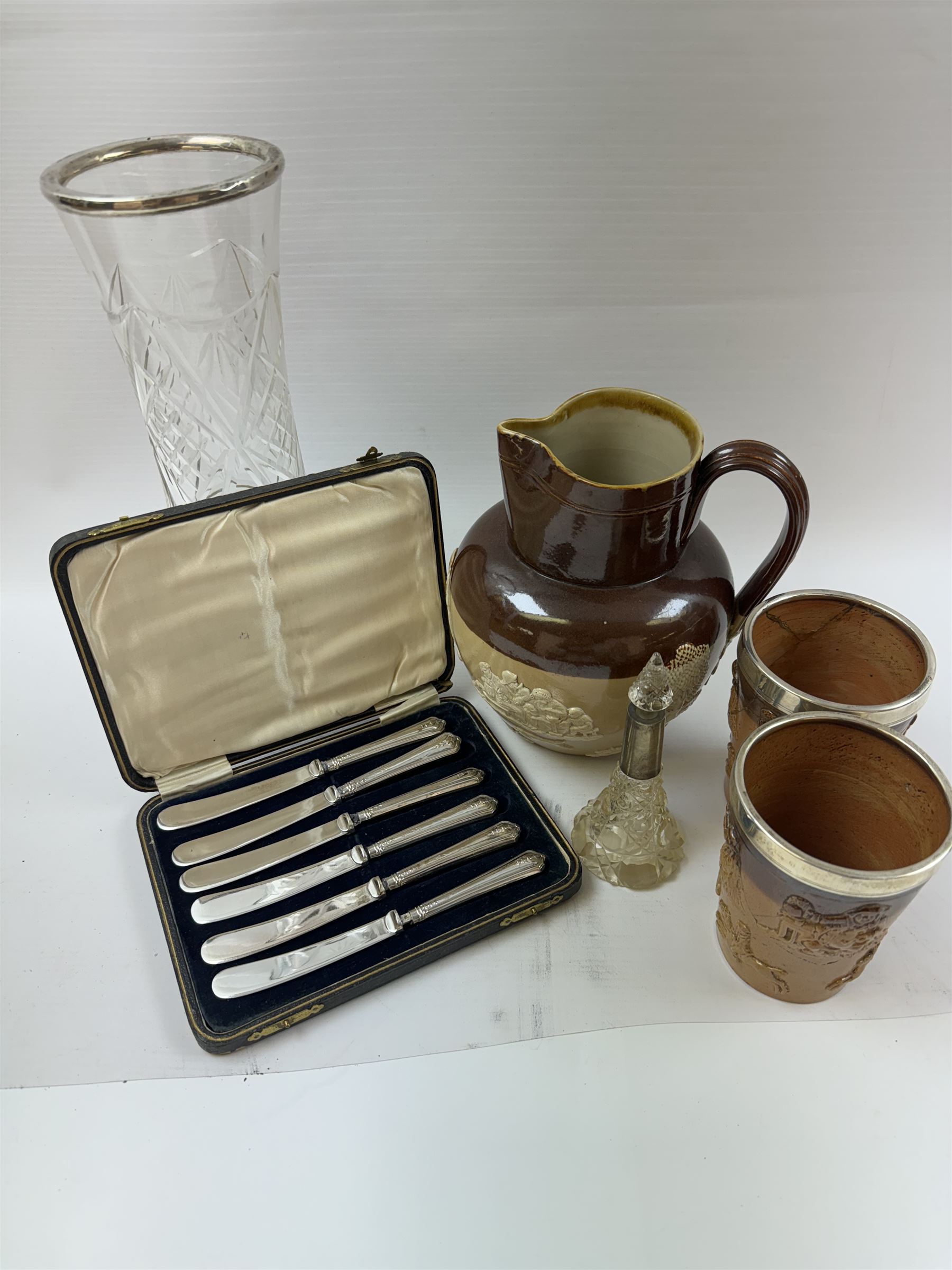 Doulton Lambeth harvest jug, together with two harvest tumblers iwth silver collars, and three other silver mounted items, including cut glass vase, scent bottle and a set of silver handled butter knives, all hallmarked 