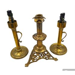 Brass candlestick with a knopt stems and triform base, together with two other brass candlestick 