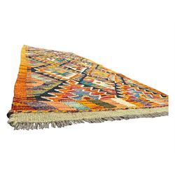 Chobi Kilim multicoloured ground runner, displaying diamond-shaped motifs in shades of blue, red, yellow, and green, accented by a bold black outline and bordered with a striped design, flatwoven with fringed edges