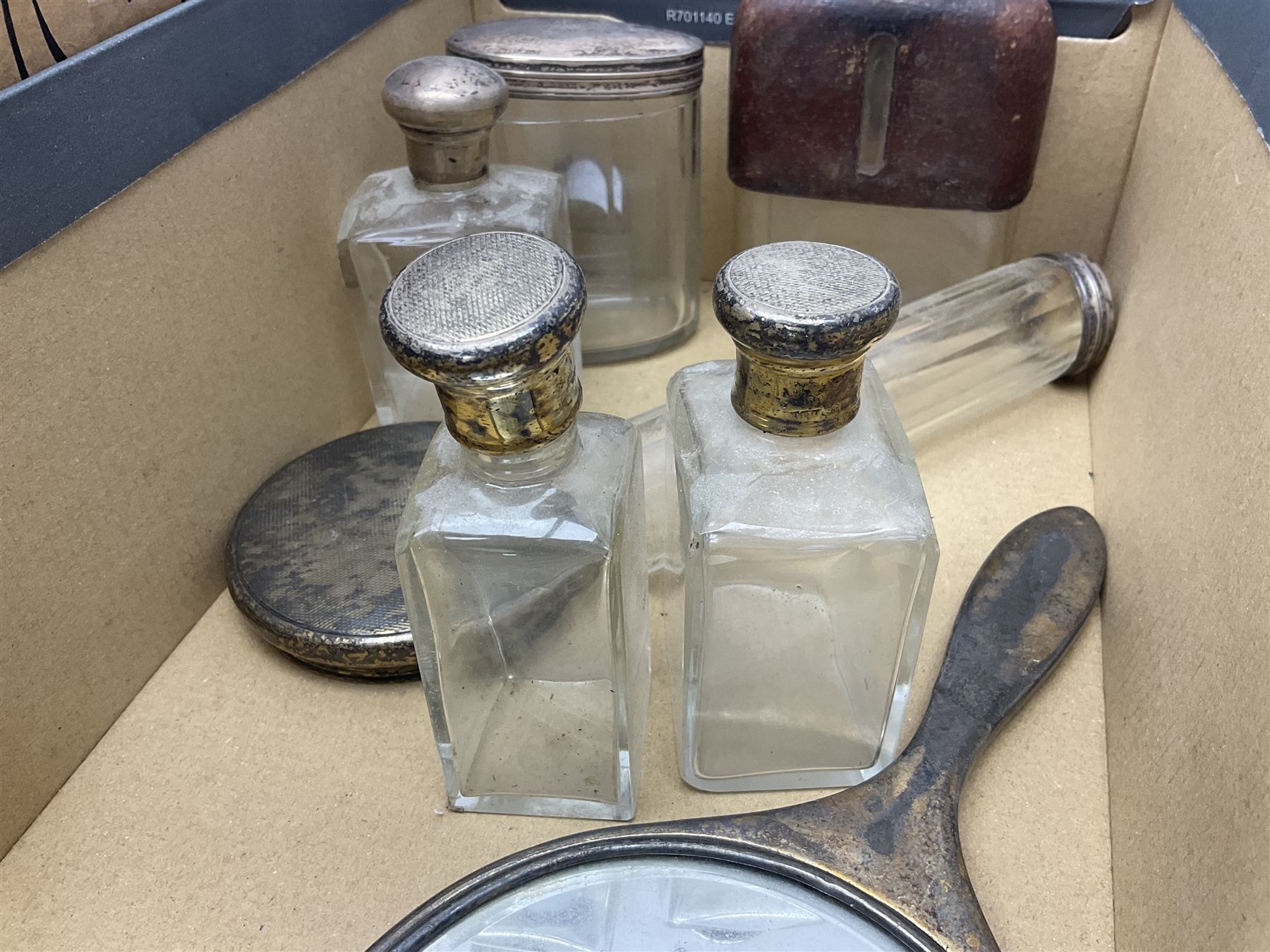 Silver mounted hand mirror and glass vanity bottles/jars with silver caps, all hallmarked, together with silver plated teapot, serving dishes and glass hip flask