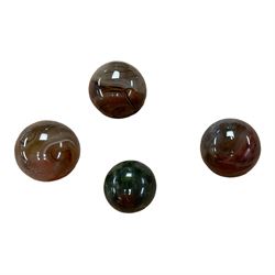 Collection of four stone spheres including banded agate examples 