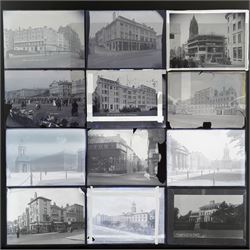 Collection of eleven plate glass negatives, depicting buildings, within a metal case 