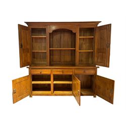 Large 20th century oak dresser, projecting cornice over open arched central section with two shelves, flanked by two panelled cupboards with two shelves, lower section with three drawers above three cupboards, on stile supports 