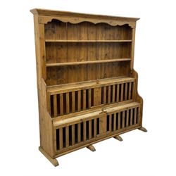 Waxed pine 'chicken coop' or 'hutch' dresser, projecting cornice over shaped frieze and three tier plate rack, the stepped waterfall lower section fitted with two slatted chicken coops, on sledge feet 