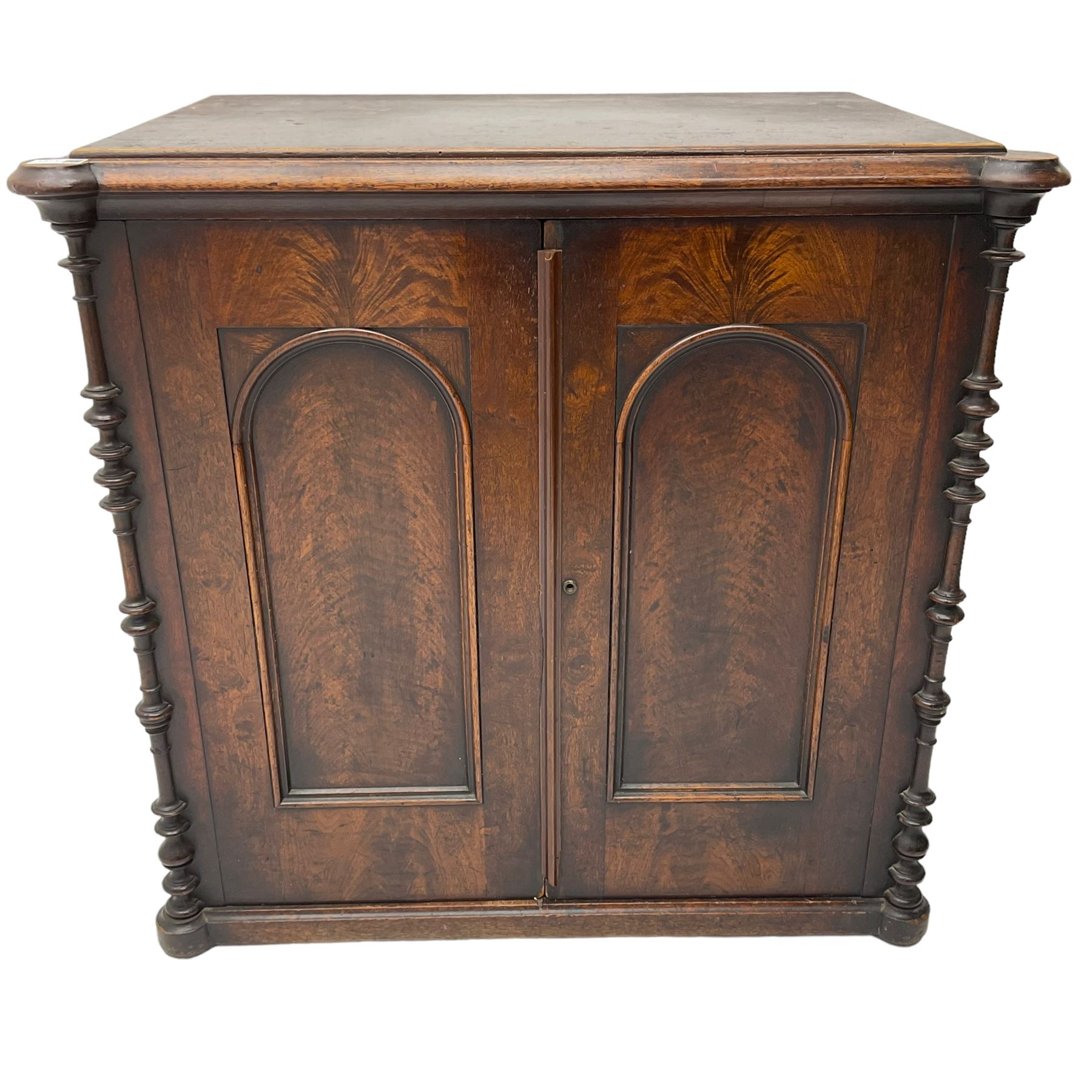 Victorian lacquered mahogany cupboard, fitted with two arch panelled doors enclosing two shelves, flanked by split turned uprights