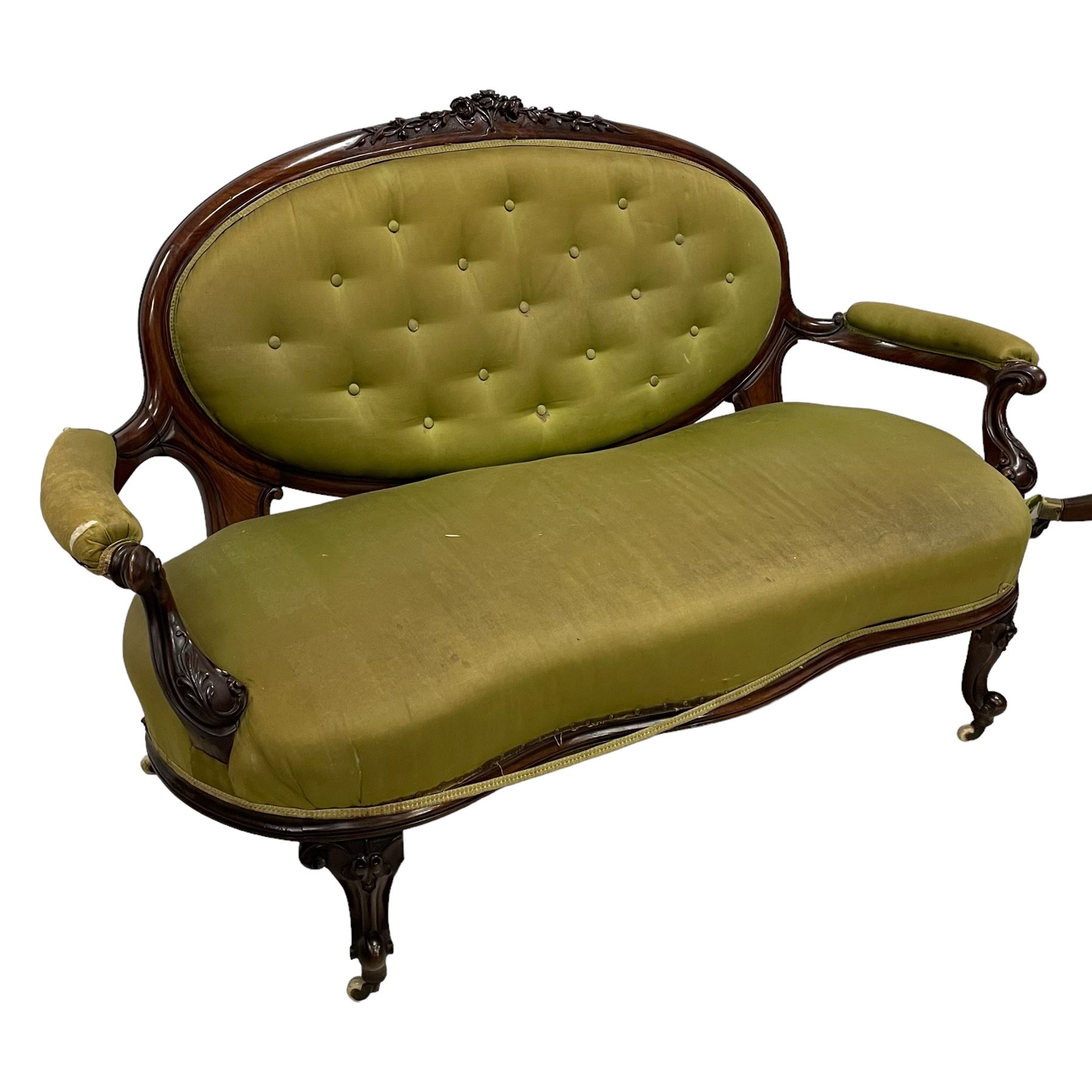 Victorian carved walnut framed two seat settee, cresting rail carved and moulded with a posy of roses and trailing foliate, over an oval back with scrolled arm terminals, serpentine fronted seat over cabriole supports with bell-flower carved knees, buttoned back and sprung seat upholstered in olive green fabric