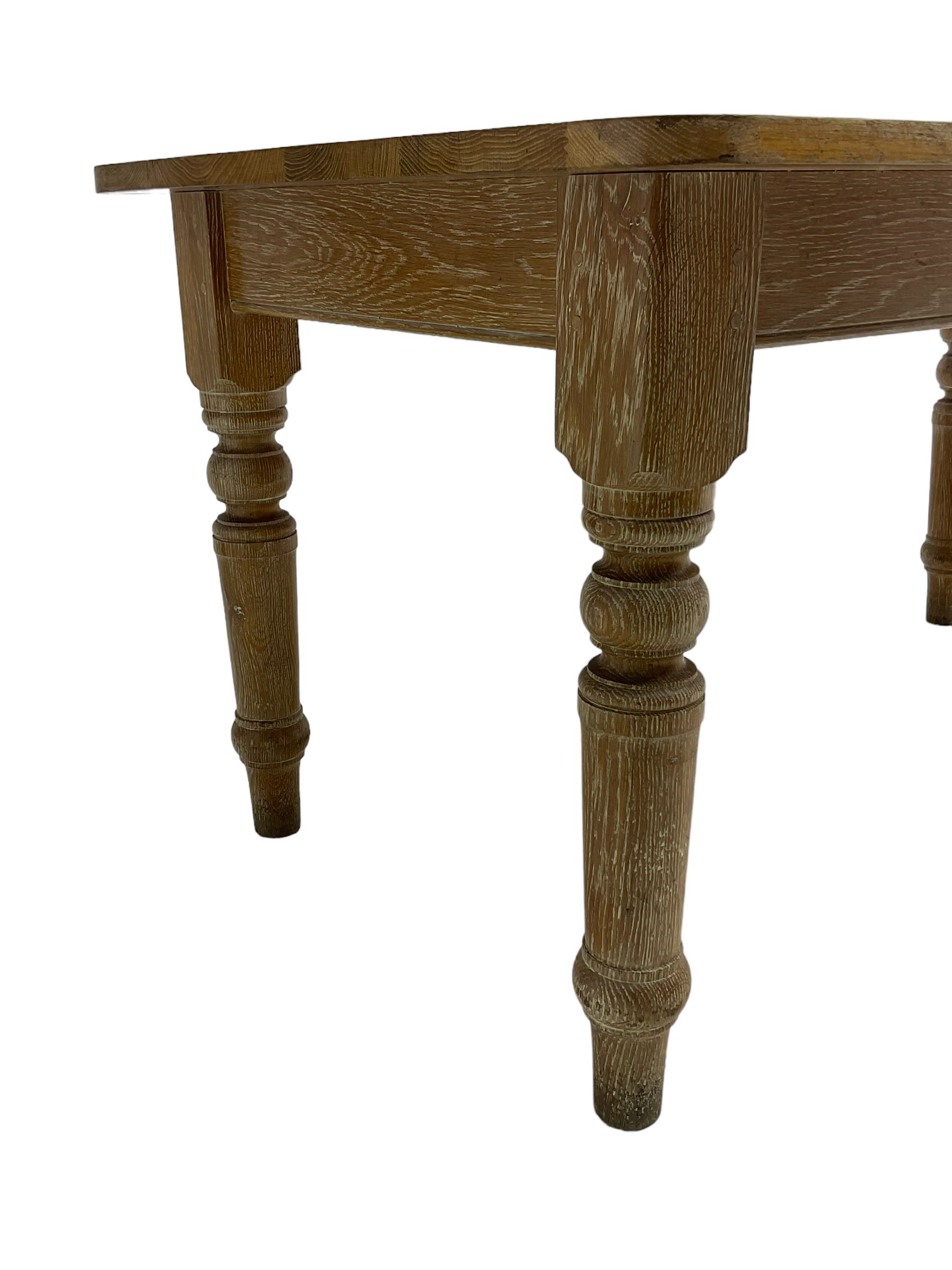 Limed oak dining table, rectangular top with rounded corners, on turned supports