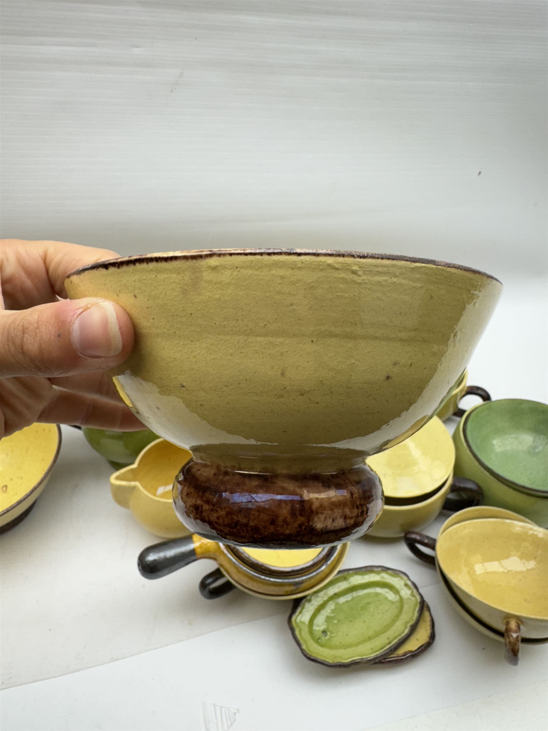 French green and yellow glazed tea and dinner wares by Etienne Noel, including milk jugs, teacups, side plates, bowls etc (43)