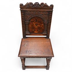 Pair of 19th century Dutch style marquetry oak hall chairs, cresting rail carved with a central green man mask with flanking scrolls, the panelled back inlaid with a bird motif within a guilloche carved arch, panelled seat over scrolling foliate carved apron, on ring turned supports united by box stretcher