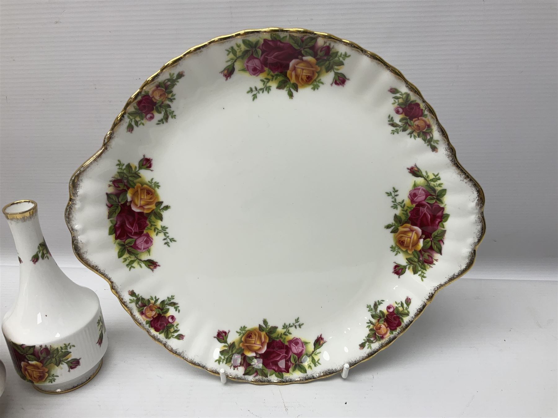 Royal Albert Old Country Roses pattern tea service for six, comprising teapot, sucrier, milk jug, dessert plates, one cake plate, one two tiered cake stand, salt and pepper pots and bud vase 