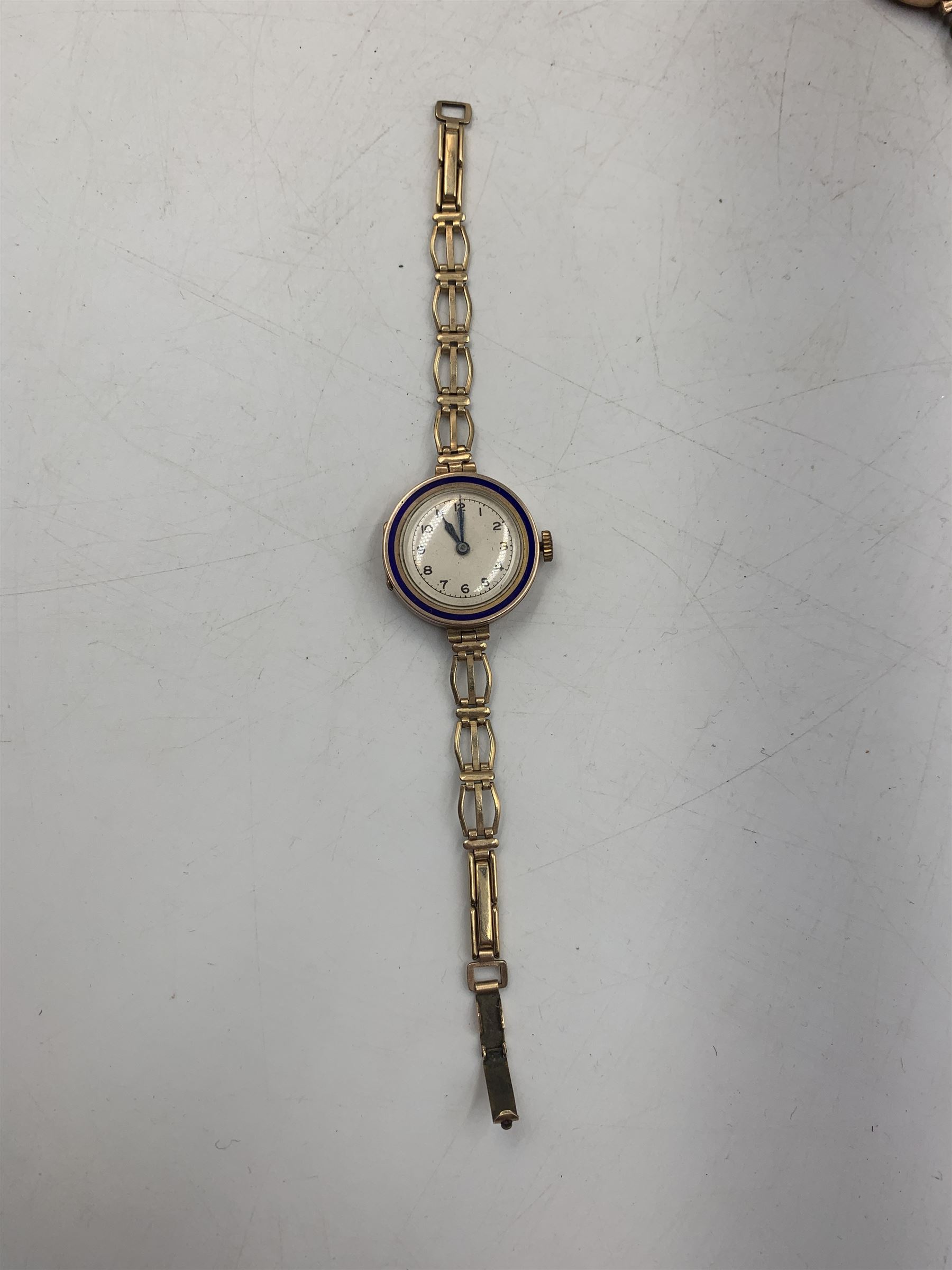 Early 20th century keyless fob watch, white enamelled dial with Roman numerals and subsidiary seconds dial, outer case stamped 14K, 9ct gold cased Rite-Tyme mechanical wristwatch, on a gilt stainless steel bracelet, a ladies 9ct gold cased mechanical movement wristwatch, with blue enameled case, on a rolled gold bracelet strap, ladies 9ct gold mechanical movement wristwatch on an expanding bracelet strap stamped 9ct and another 9ct gold cased mechanical movement wristwatch, together ladies Rotary 9ct gold cased mechanical wristwatch and ladies Bulova rolled gold mechanical wristwatch (lacking straps)