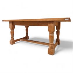 Waxed pine refectory table, boarded top with cleated ends, on turned supports united by H-stretchers 