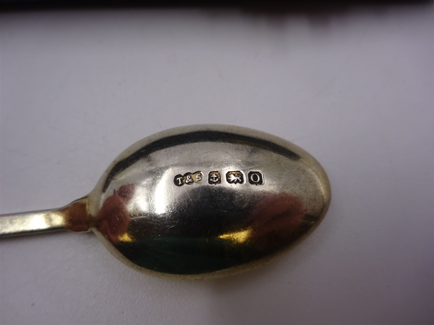 Set of six silver coffee spoons, each with enamelled daffodil decoration to terminal, hallmarked Turner & Simpson Ltd, Birmingham 1938, contained within fitted case