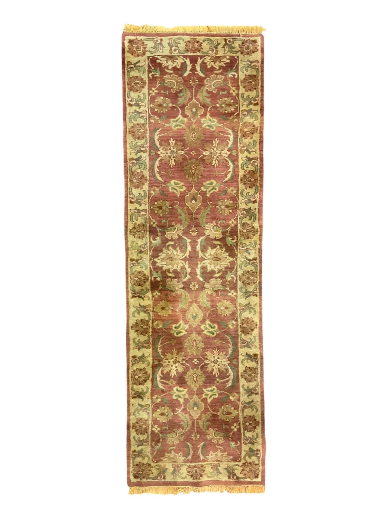 Persian Zeigler crimson ground runner rug, field decorated with scrolling foliate patterns with palmette motifs, enclosed by a camel guard band with further floral designs