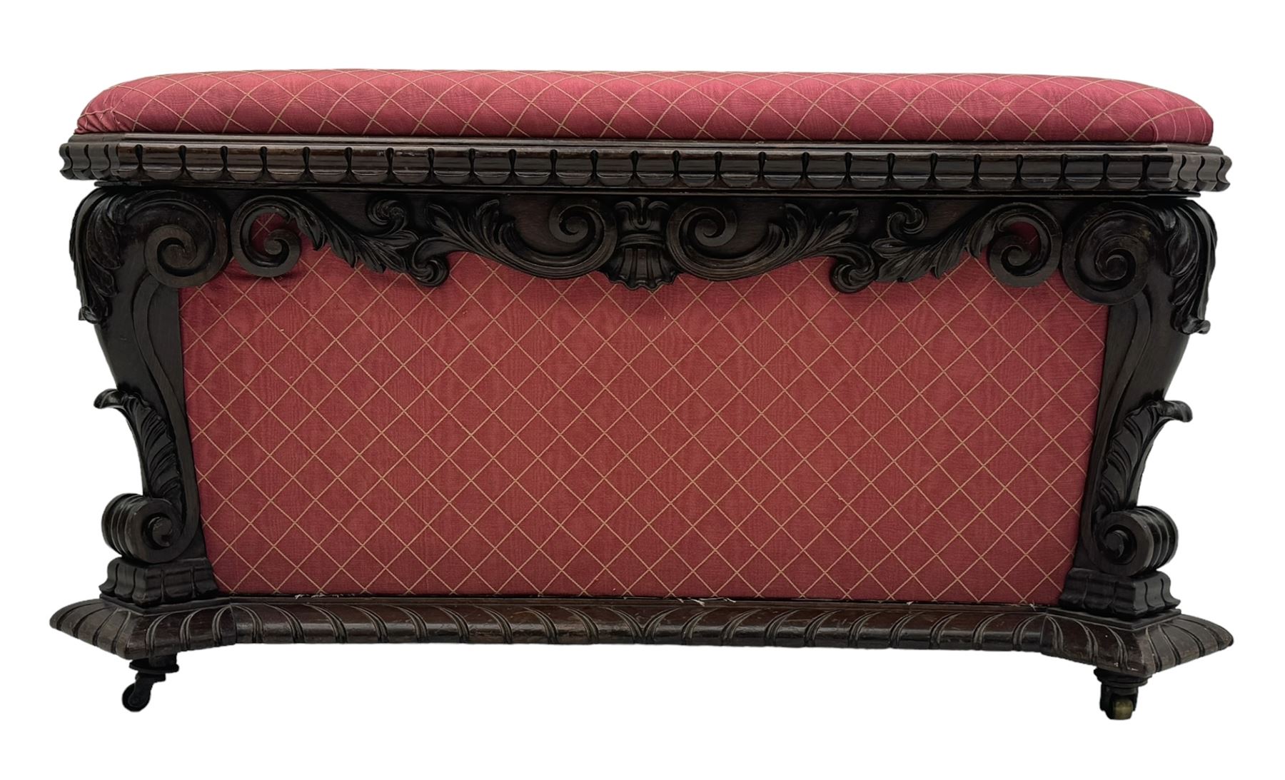 19th century rosewood and simulated rosewood ottoman footstool, tapering canted rectangular form enclosed by hinged lid, upholstered in red fabric, the frieze decorated with scrolling leaves, each corner with scrolled acanthus leaf supports, projecting shallow gadroon moulded edge 