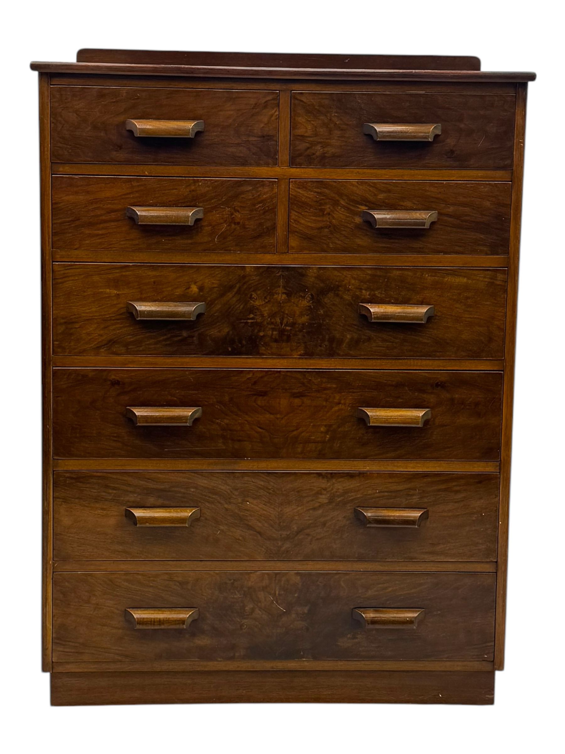 Early 20th century walnut chest, fitted with four short and four long drawers, on recessed plinth base