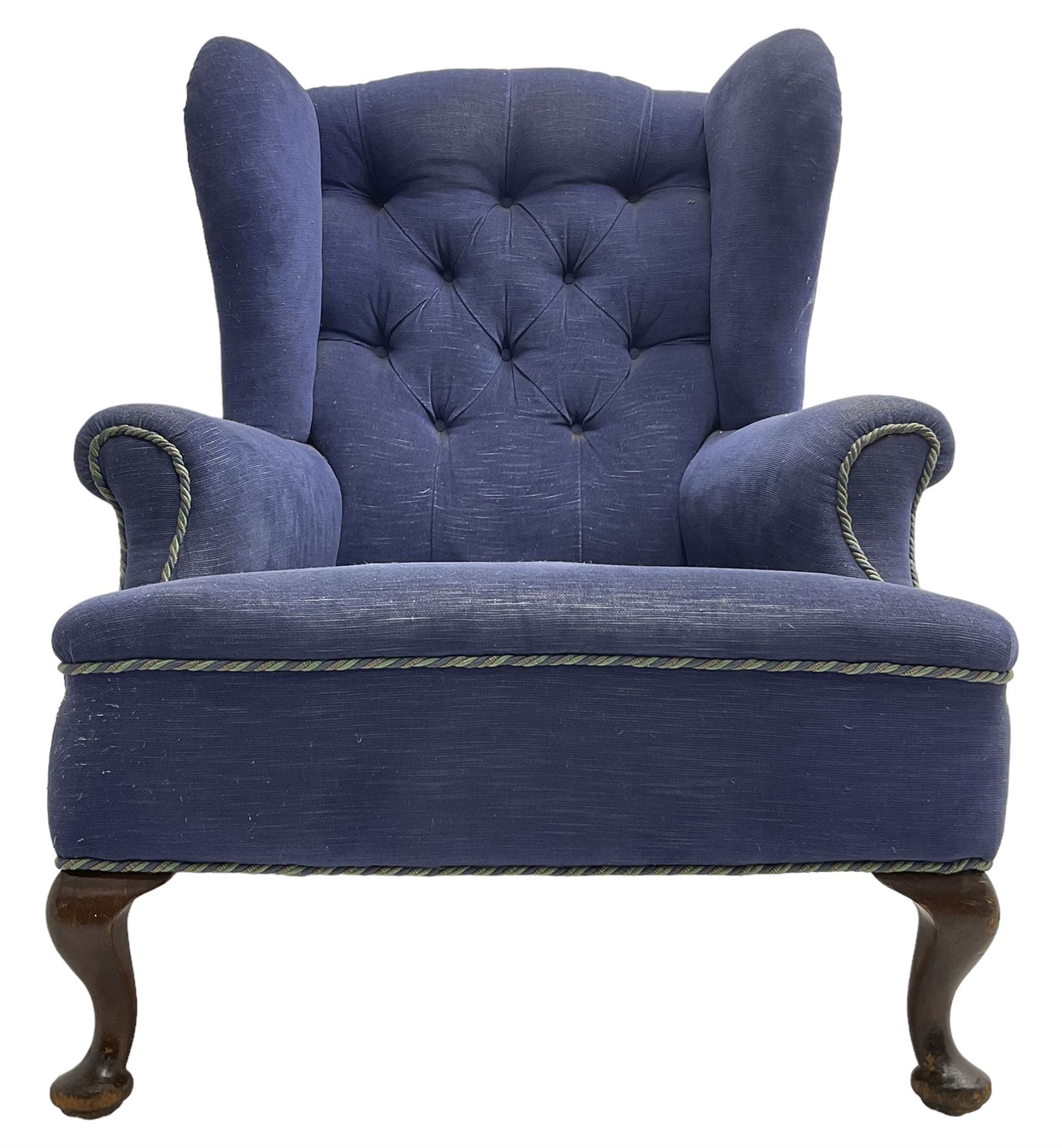 Early 20th century wingback armchair, upholstered in buttoned blue fabric, rolled and scrolled arms, on cabriole feet