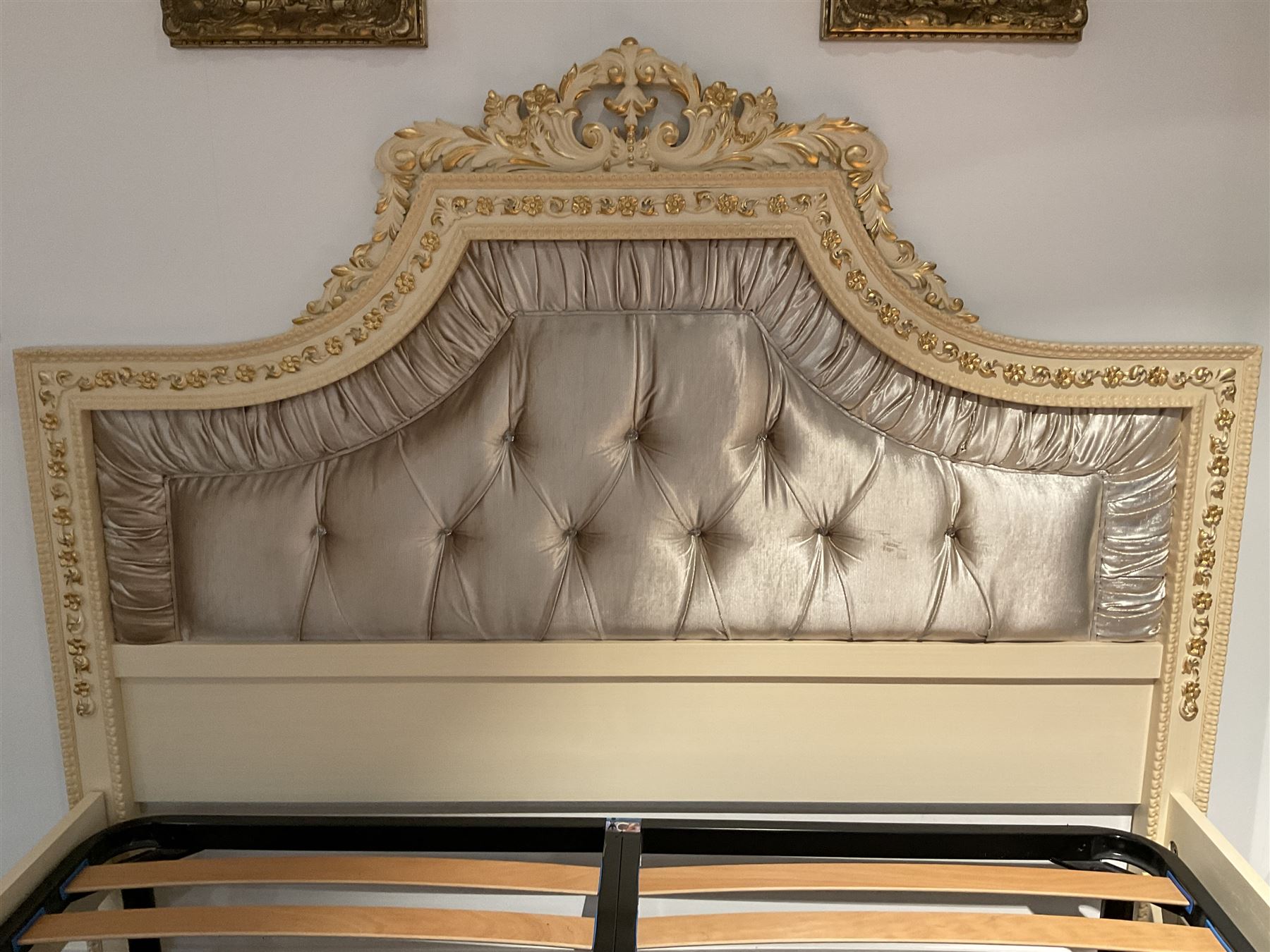 Barnini Oseo - super king 6' 'Reggenza' bedstead, the headboard with a pierced cartouche pediment with extending scrolling foliage, decorated with trailing gilt flower heads, upholstered in buttoned lilac velvet, raised on cabriole feet, in a cream finish