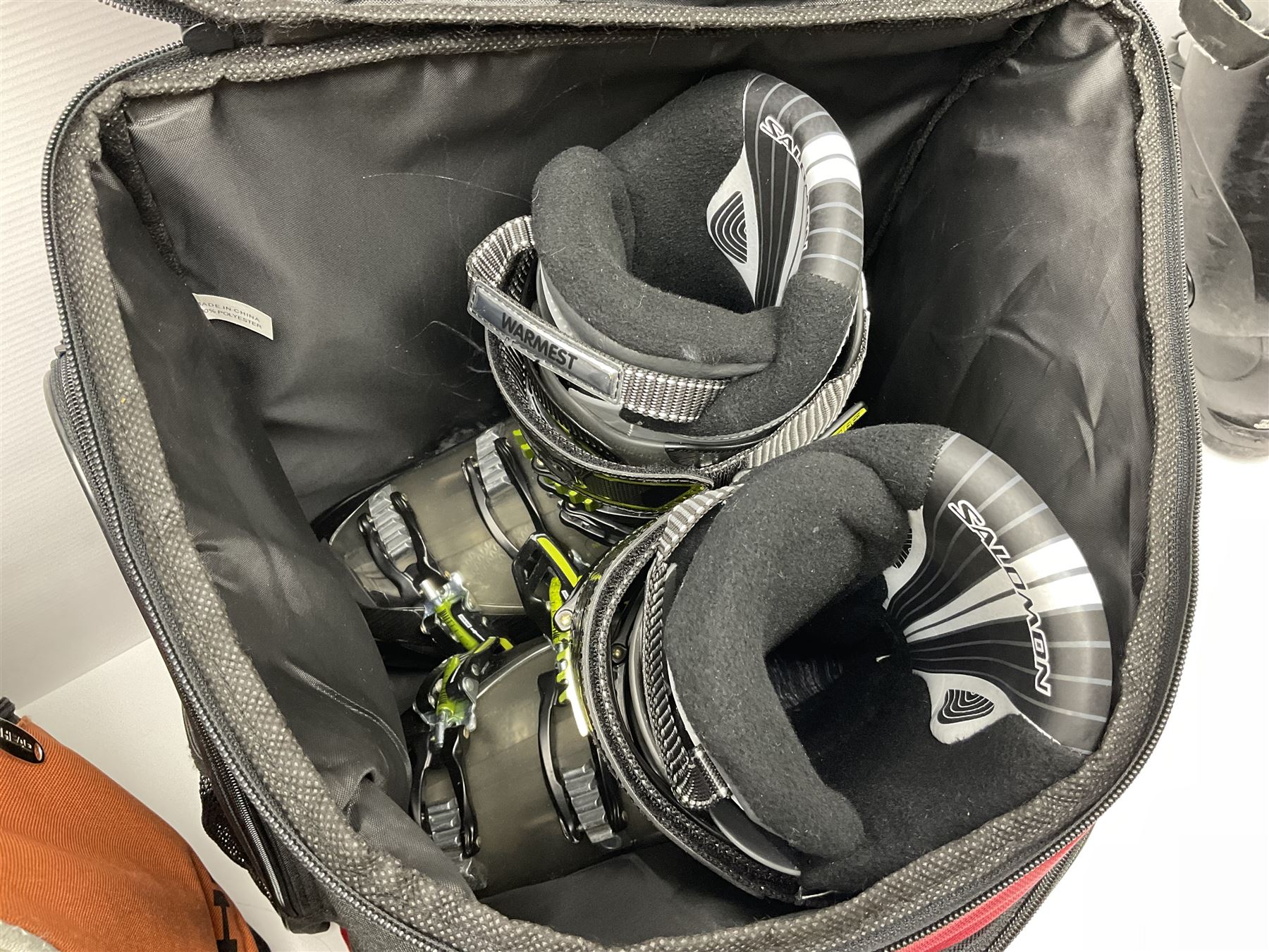 Three sets of Salomon ski boots (two as new), together with associated clamps