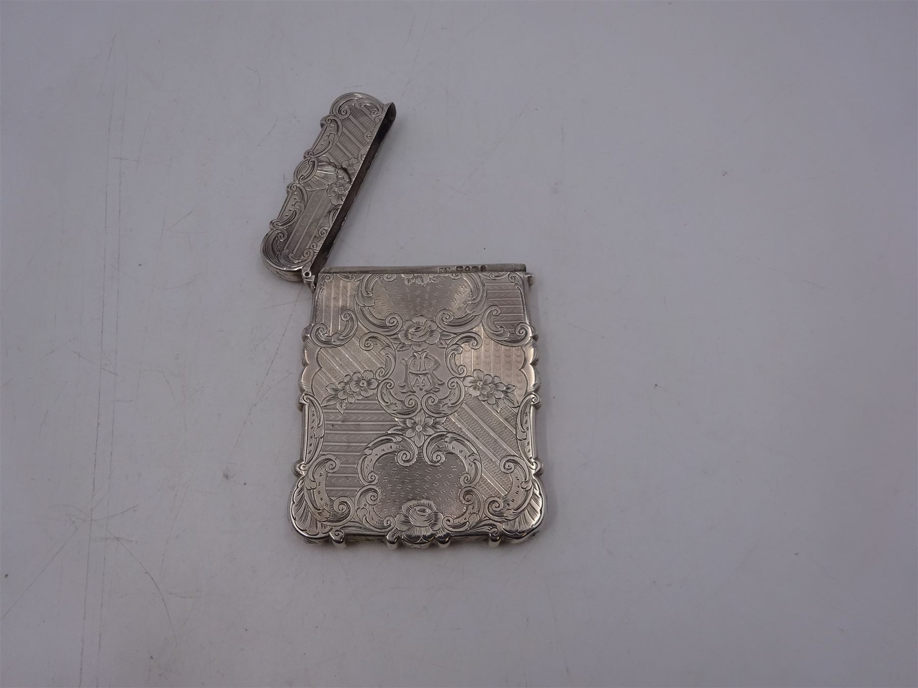 Victorian silver card case, of rectangular form with shaped edges, engine turned and floral decoration, with engraved hallmarked Nathaniel Mills, Birmingham 1845, H10cm