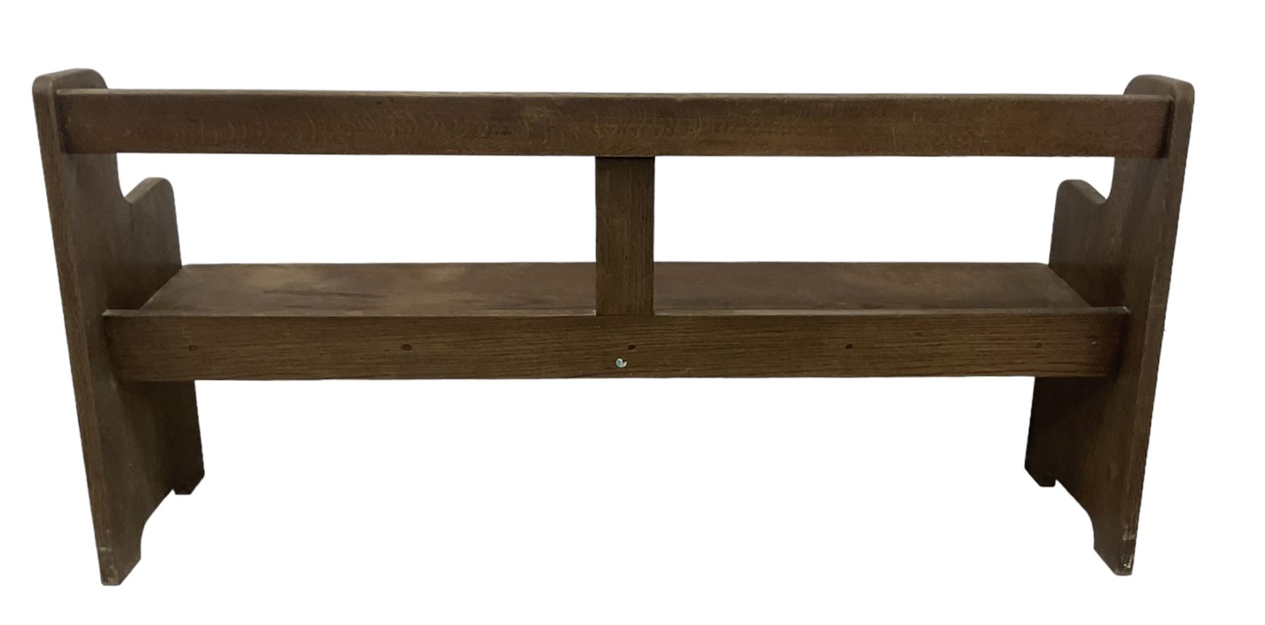 Early 20th century oak church pew or hall bench, open back over single plank seat, on shaped end supports