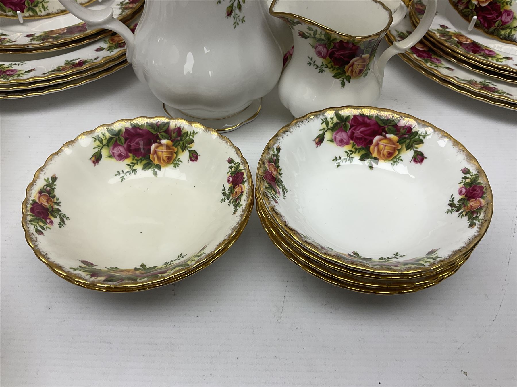 Royal Albert Old Country Roses pattern coffee set for four, comprising coffee pot, milk jug, cups and saucers, cake plate, together with six dinner plates, side plates etc (34) 