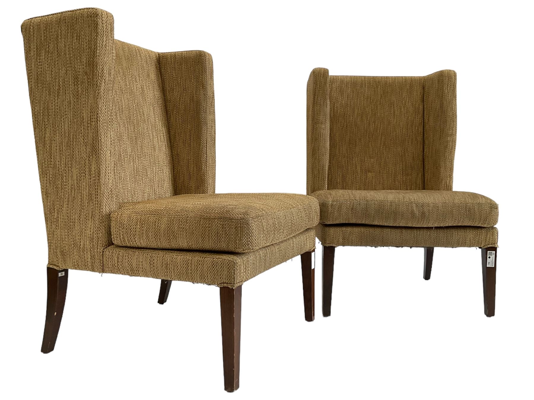 Two wing back armchairs, upholstered in oatmeal fabric