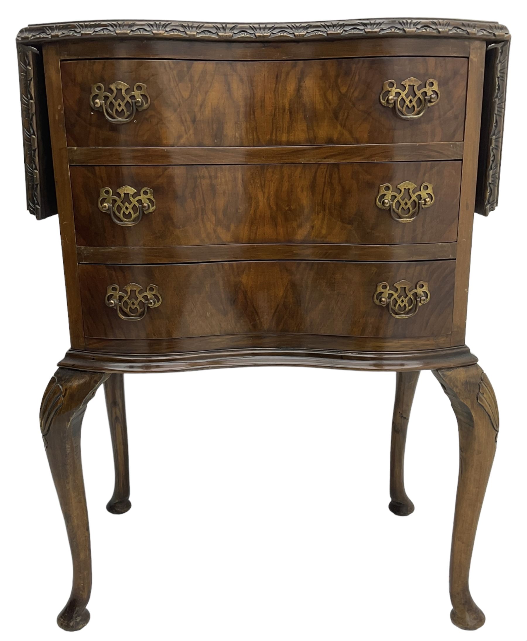 Early to mid-20th century figured walnut lamp table, shaped drop-leaf top with foliate carved edge, fitted with three drawers, on shell carved cabriole supports