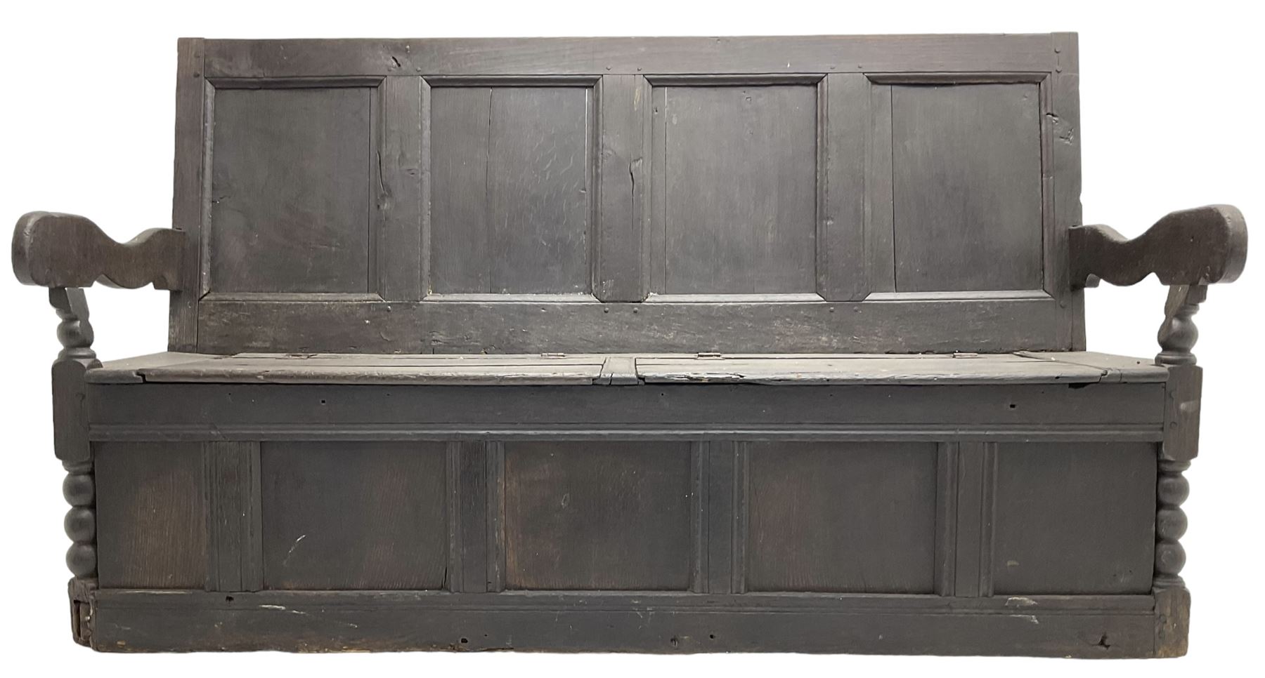 18th century oak box seat settle bench, pegged construction with quadruple panelled back over double hinged box seat, shaped projecting arms with scroll carved terminal detail, on block and bobbin turned front supports, panelled front within moulded frame