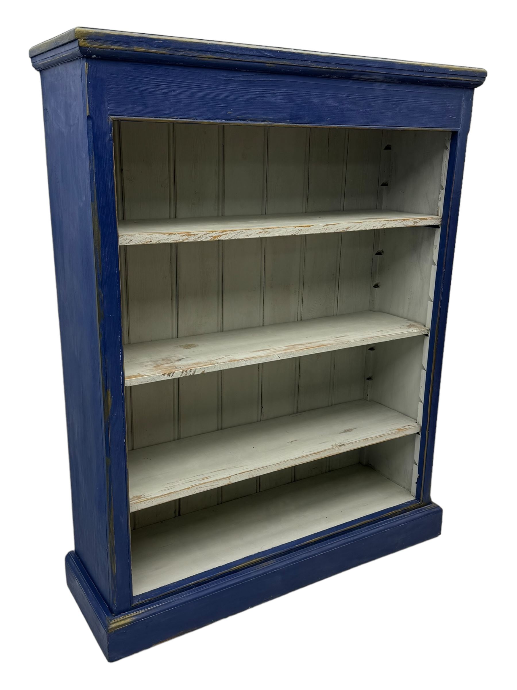 Pine blue painted open bookcase, moulded rectangular top over three white painted adjustable shelves, on plinth base