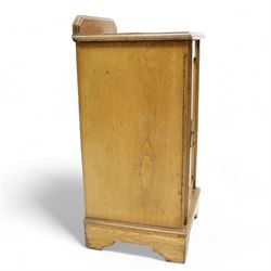 Late Victorian ash and walnut bedside pot cupboard, raised canted back over square moulded top, enclosed by single panelled door with figured walnut veneer, on bracket feet 