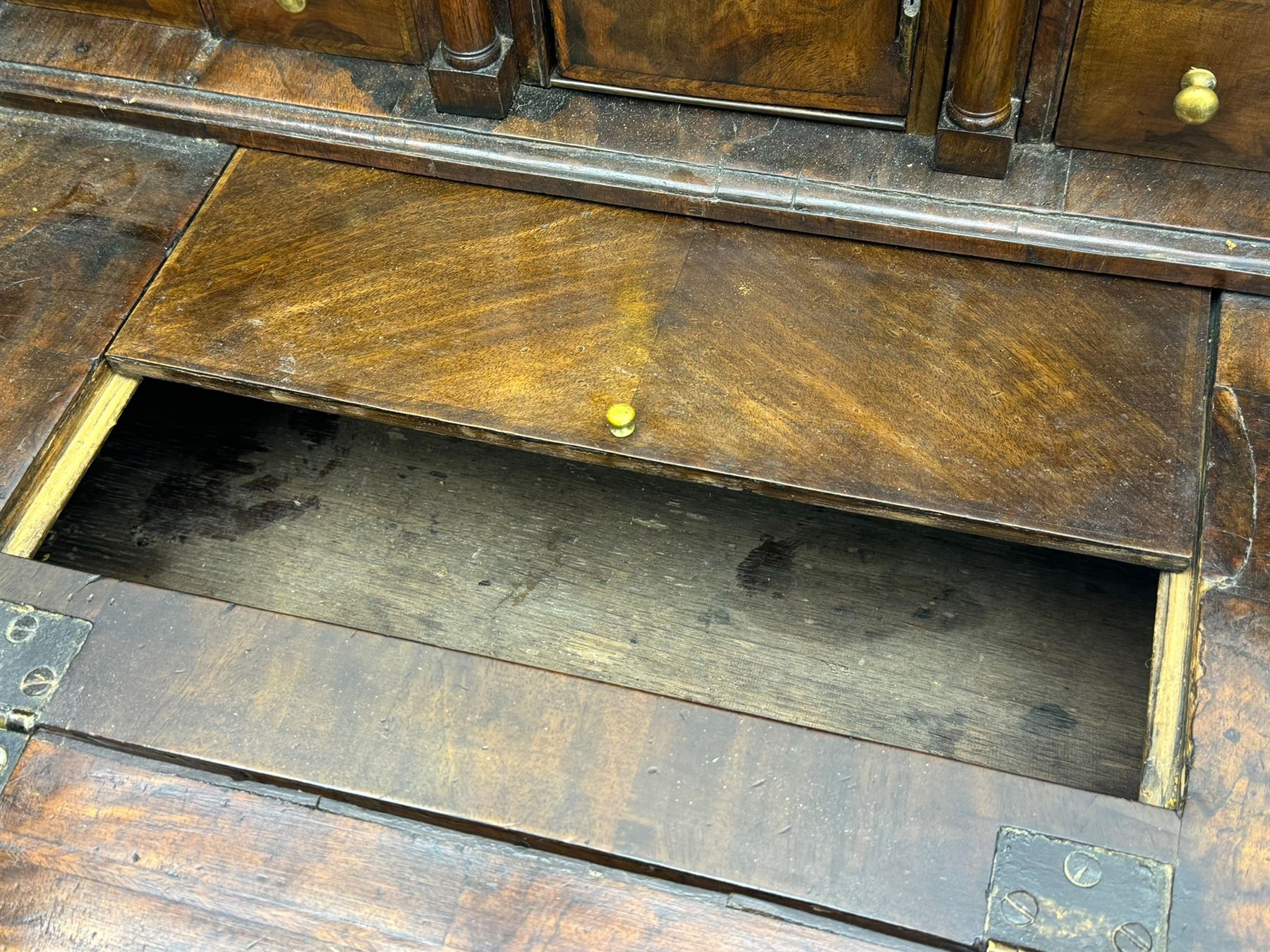 18th century walnut bureau, fall-front enclosing fitted interior with drawers and pigeonholes, over two short and two long drawers with brass escutcheon plates and handles, raised on bracket feet