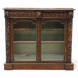 Victorian carved oak glazed bookcase, projecting cornice with stylised leaf and floral car...