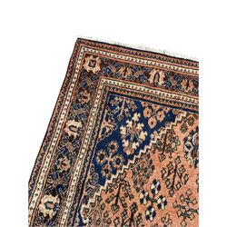 Persian Joshaghan peach and blue ground rug, central stepped lozenge medallion surrounded by bunches of floral motifs, repeating border decorated with stylised plant motifs, within multiple guard stripes