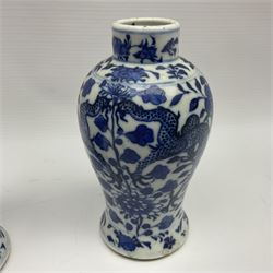 Pair of late 19th/early 20th century Chinese blue and white vases, each of baluster form, painted with dragons amidst flowers, each with Kangxi character marks beneath, H14cm 